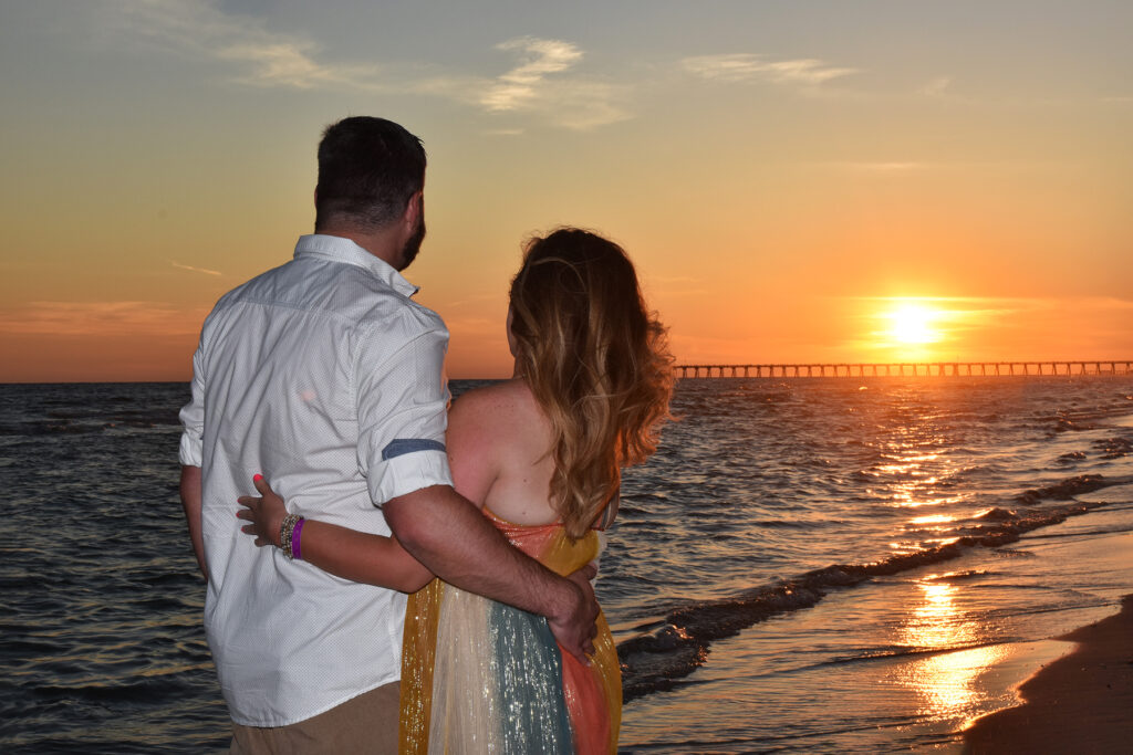 sunset beach photo with a couple at the beach