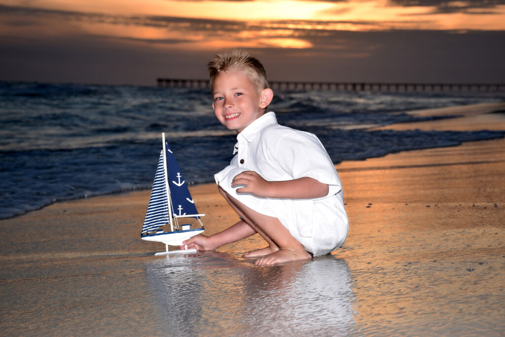 Boy on the beach at sunset by one of our best photographer in Panama City Beach.