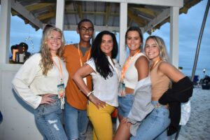 Posed group photo at a beach bonfire in PCB