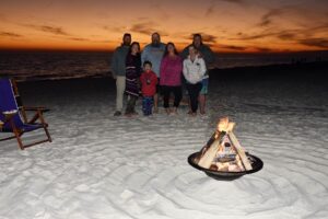 Family photo with bonfire on Destin beach