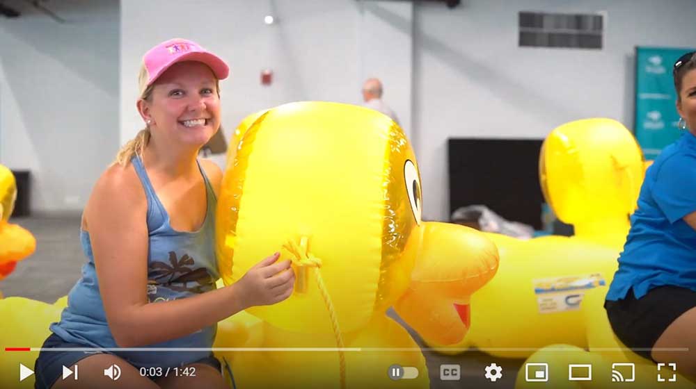 A woman rides on a big duck. Hire videographers for events in Panama City Beach.