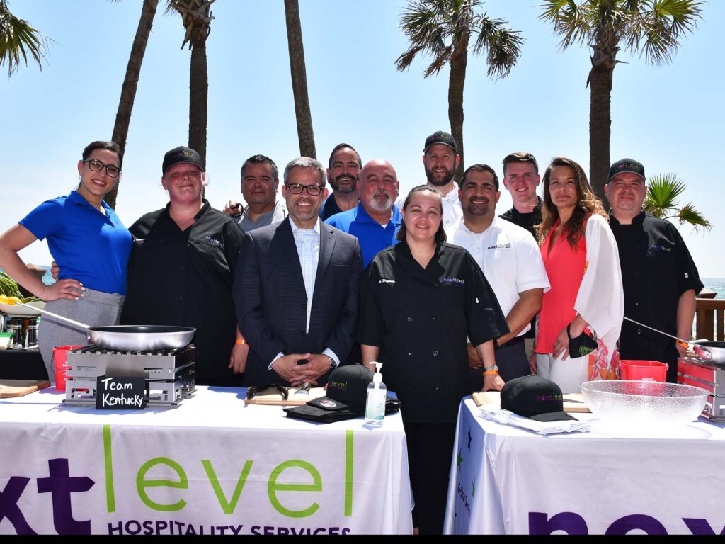 Event photographer captures a group photo at a hospitality event.