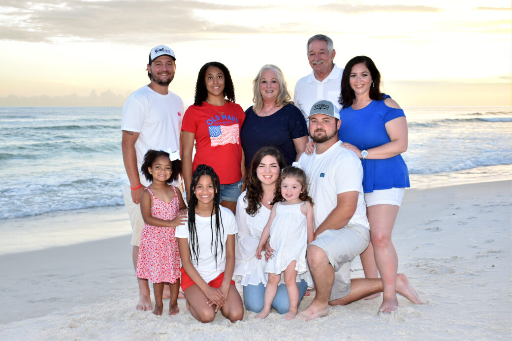 A family getting a professional photo taken at the beach