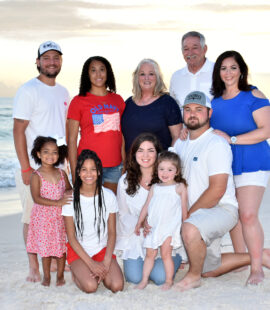 A family getting a professional photo taken at the beach