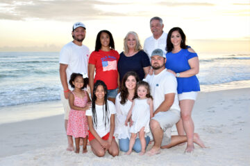 A family getting a professional photo taken at the beach