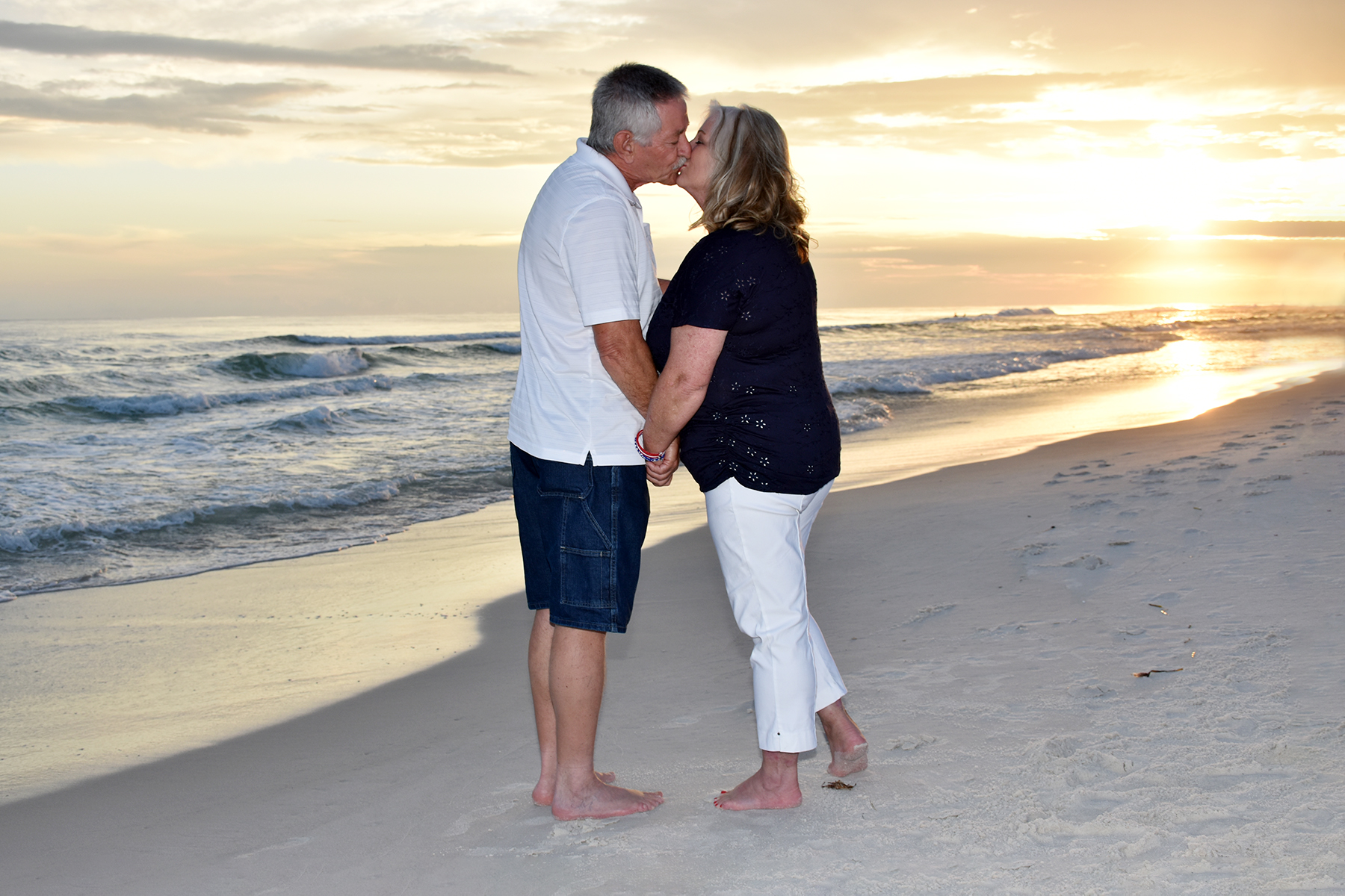 Couple on the beach celebrating Independence Day with a sunset beach photo