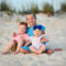 Siblings near dunes in Panama City Beach smile for our photographer.