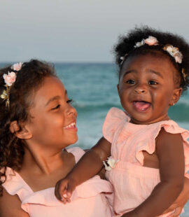 Adorable baby smiling big for the camera.